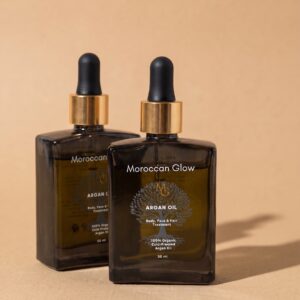 Zwei Flaschen Moroccan Glow Arganöl à 50 ml aus Braunglas mit goldenem Ring und schwarzer Pipette