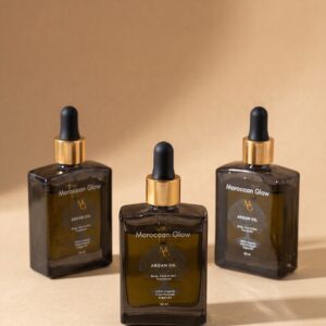 Drei Flaschen Moroccan Glow Arganöl à 50 ml aus Braunglas mit goldenem Ring und schwarzer Pipette